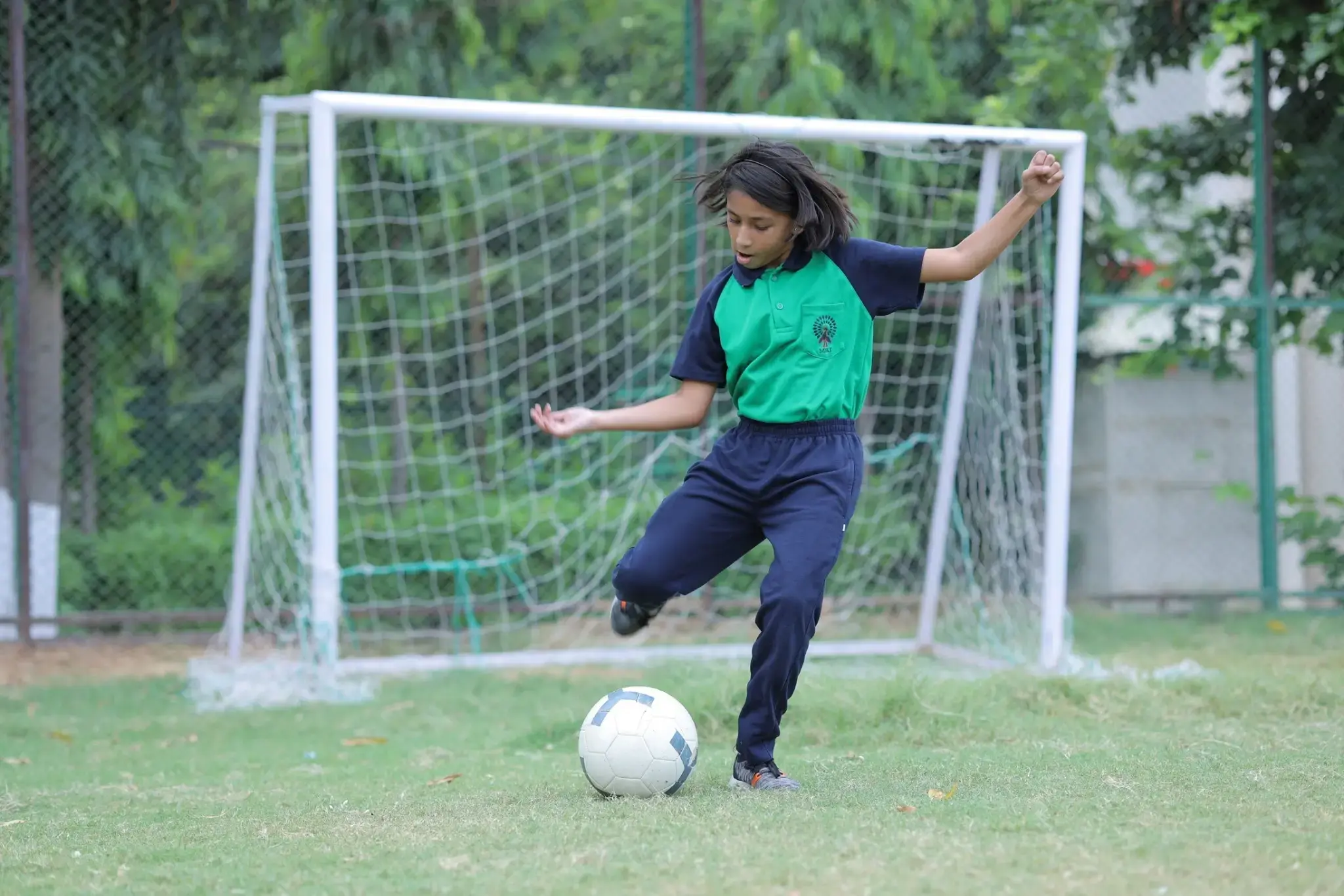 A girl student playing Football