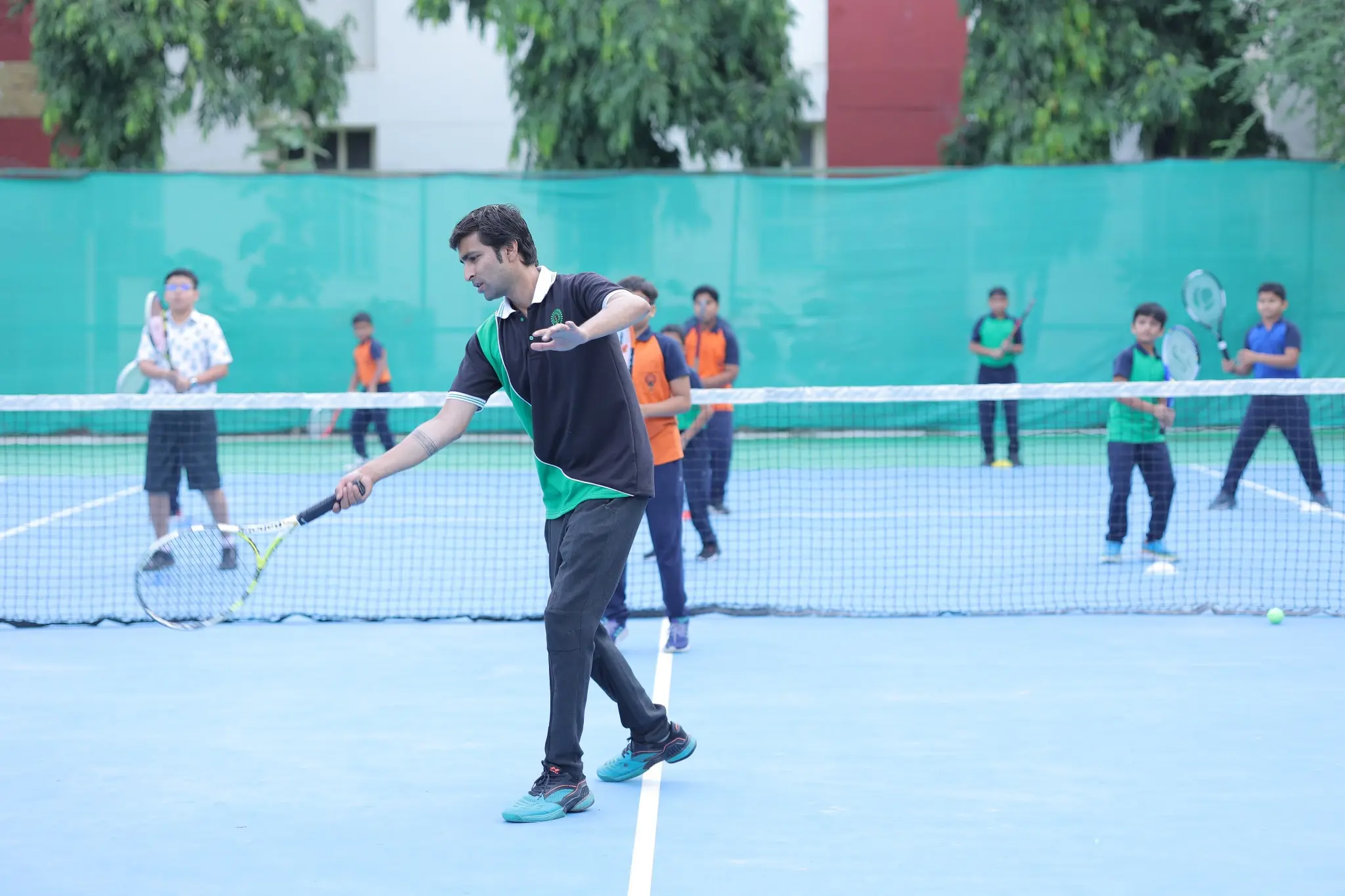Sports coach of Mayoor School giving training of Lawn tennis