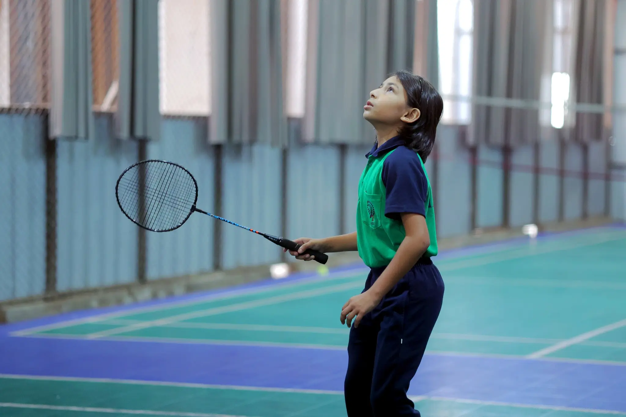 girl student playing badminton