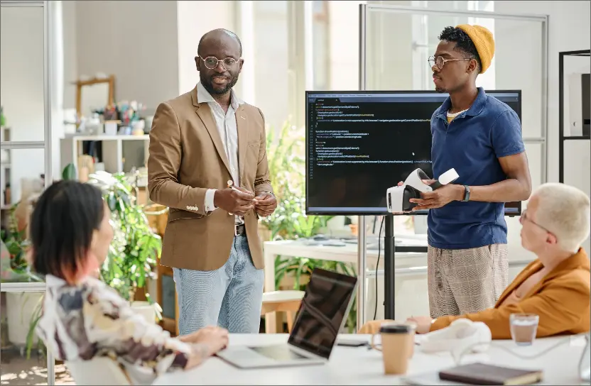 Colleagues testing new VR software application in a modern tech workspace environment