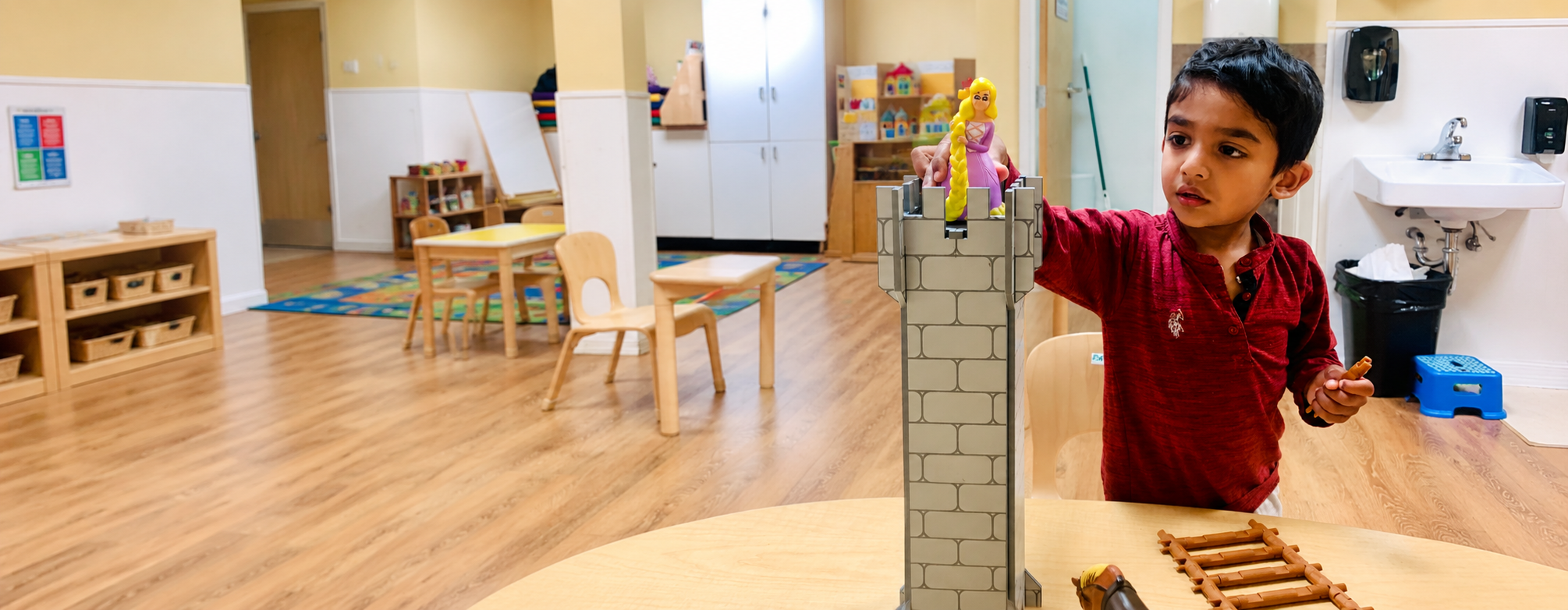 Child building blocks in Montessori classroom